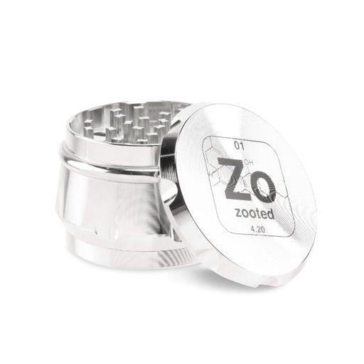 https://mjwholesale.com/cdn/shop/products/zooted-premium-4-piece-grinder-63mm-silver-1-count-5-count-or-10-count-grinders_512x512.jpg?v=1675227806